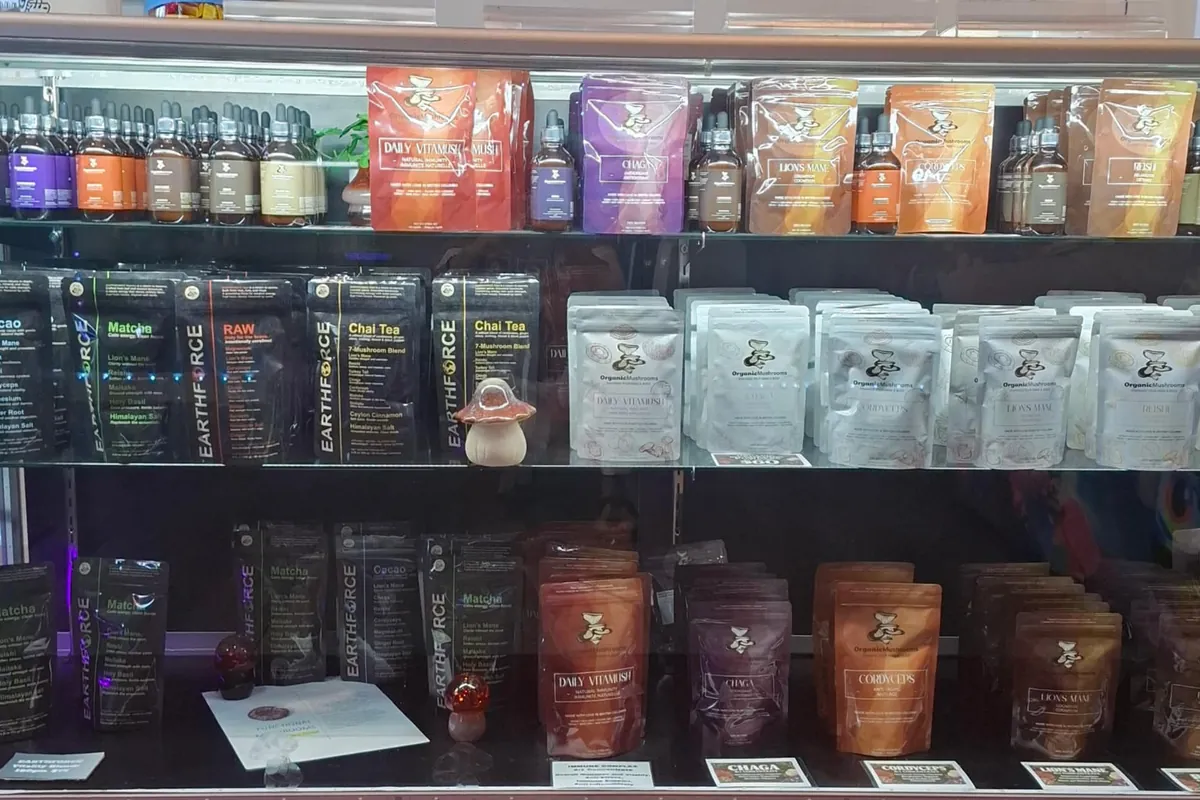Shelf of functional mushroom tinctures and pouches at The Mushroom Hut